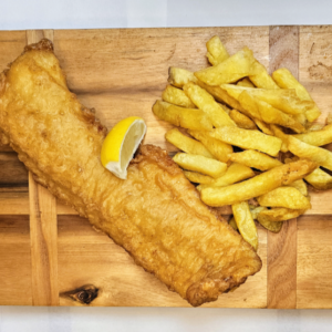 Battered Cod and Chips in a box with a lemon wedge laid out on a wooden board