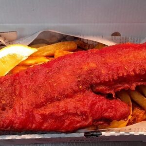 Battered Masala Cod and Chips in a box with a lemon wedge